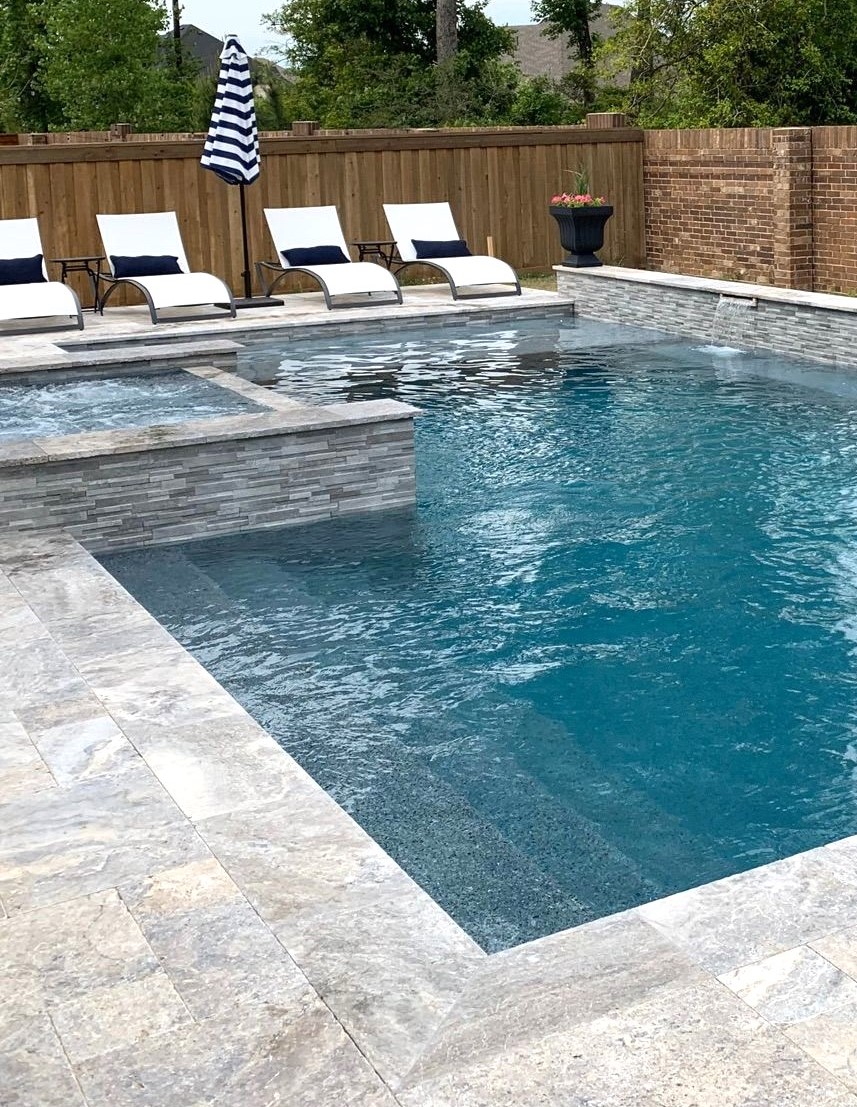 In-ground pool with attached spa and tanning ledge